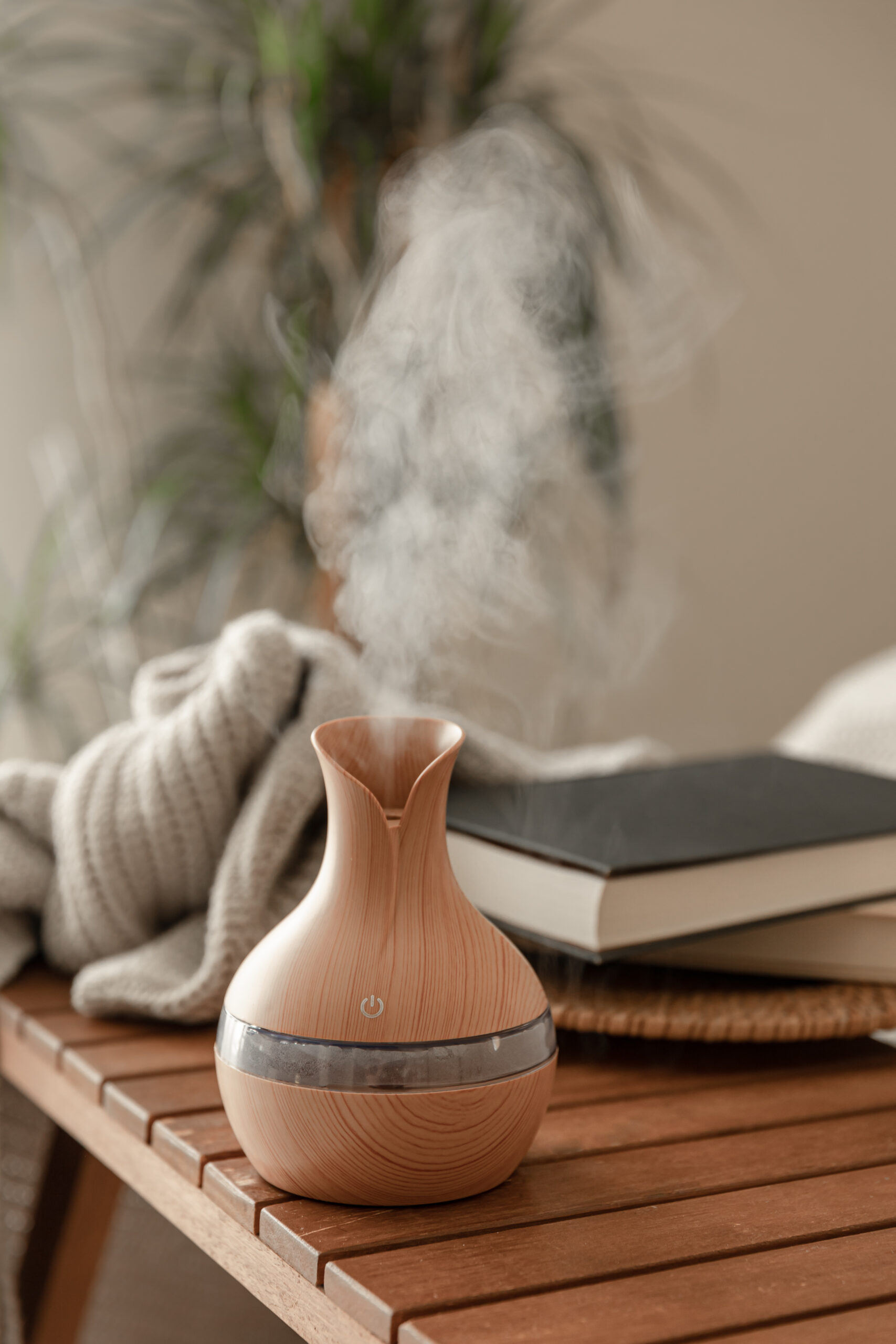 Aroma oil diffuser lamp on a blurred background in the interior of the room.